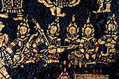 Wat Xieng Thong temple in Luang Prabang, Laos. Detail of the  intricate gold stencilling on black lacquer that decorate the walls of the sim. 